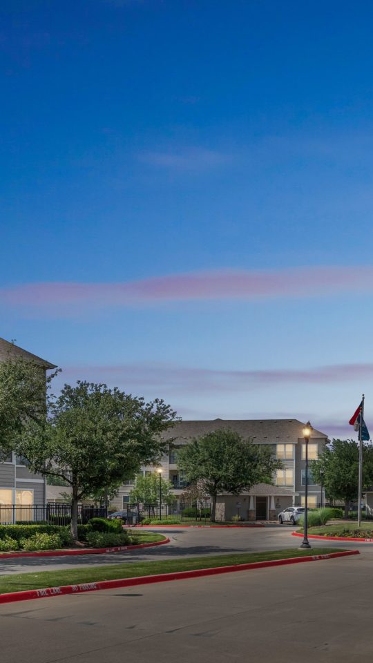 the entrance to a residential community at night at The Wyatt at Presidio Junction