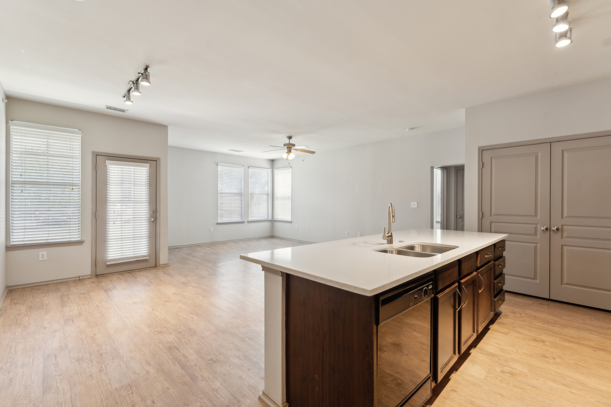 an empty kitchen with hardwood floors and a large window at The  Wyatt at Presidio Junction