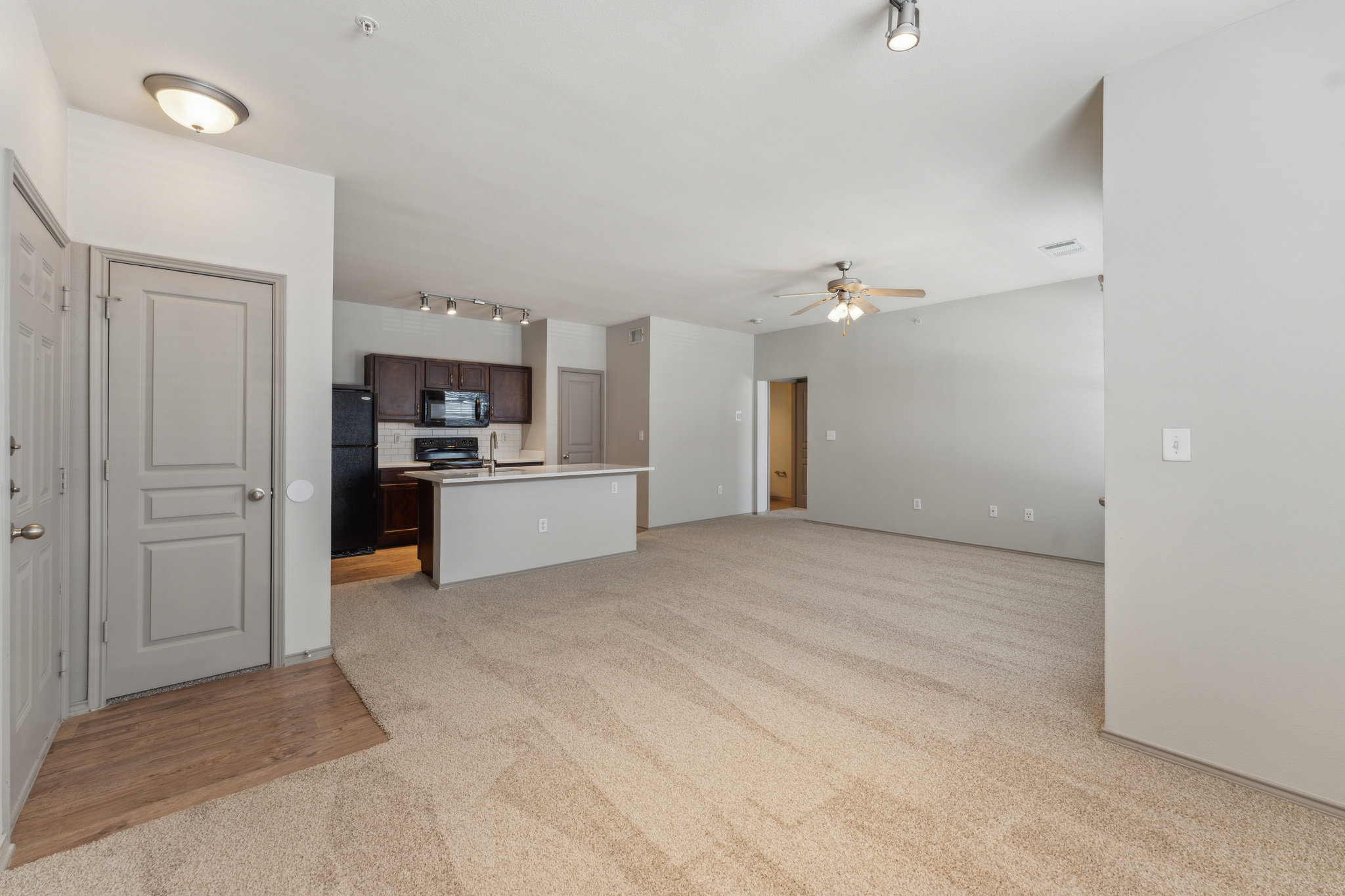 an empty room with carpet and a ceiling fan at The  Wyatt at Presidio Junction