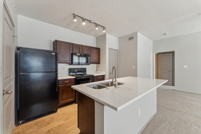a kitchen with stainless steel appliances and black appliances at The Wyatt at Presidio Junction