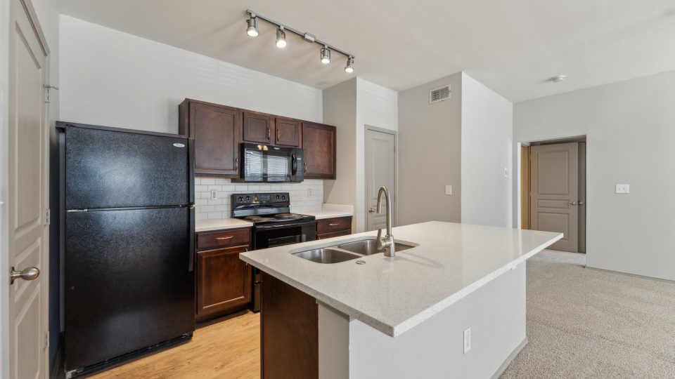 a kitchen with stainless steel appliances and black appliances at The Wyatt at Presidio Junction