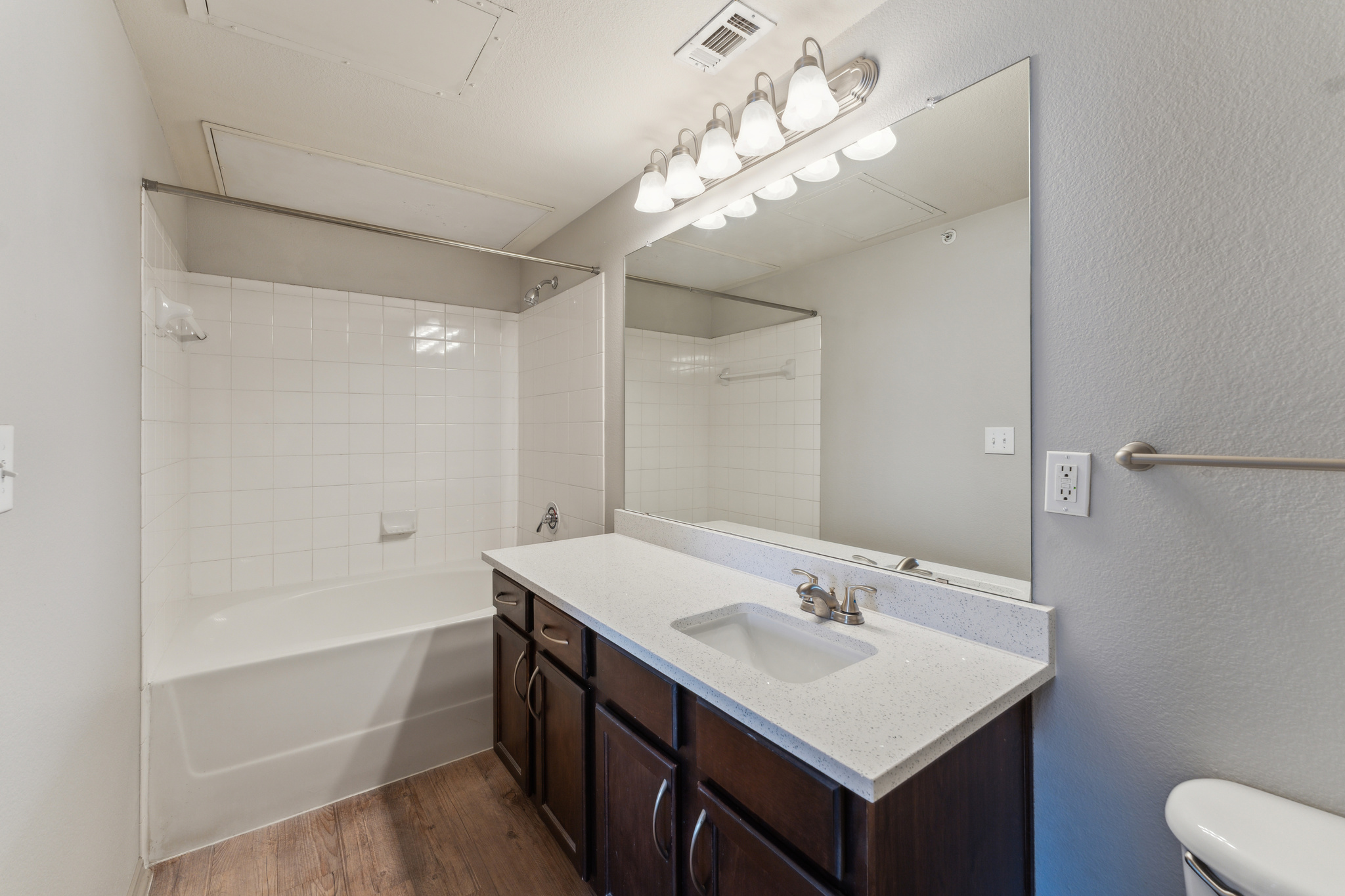 a bathroom with a tub and sink and a mirror at The  Wyatt at Presidio Junction
