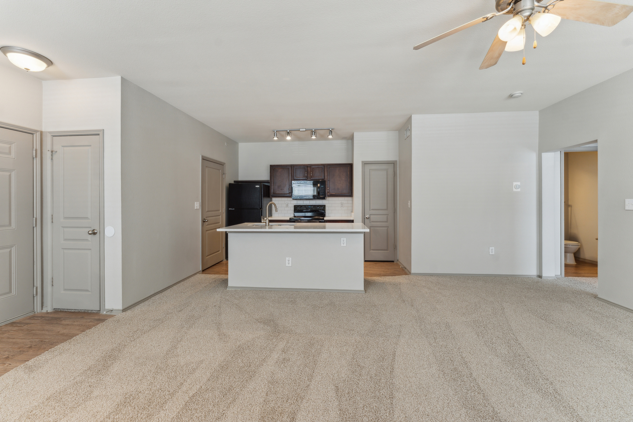 an empty room with carpet and ceiling fan at The  Wyatt at Presidio Junction