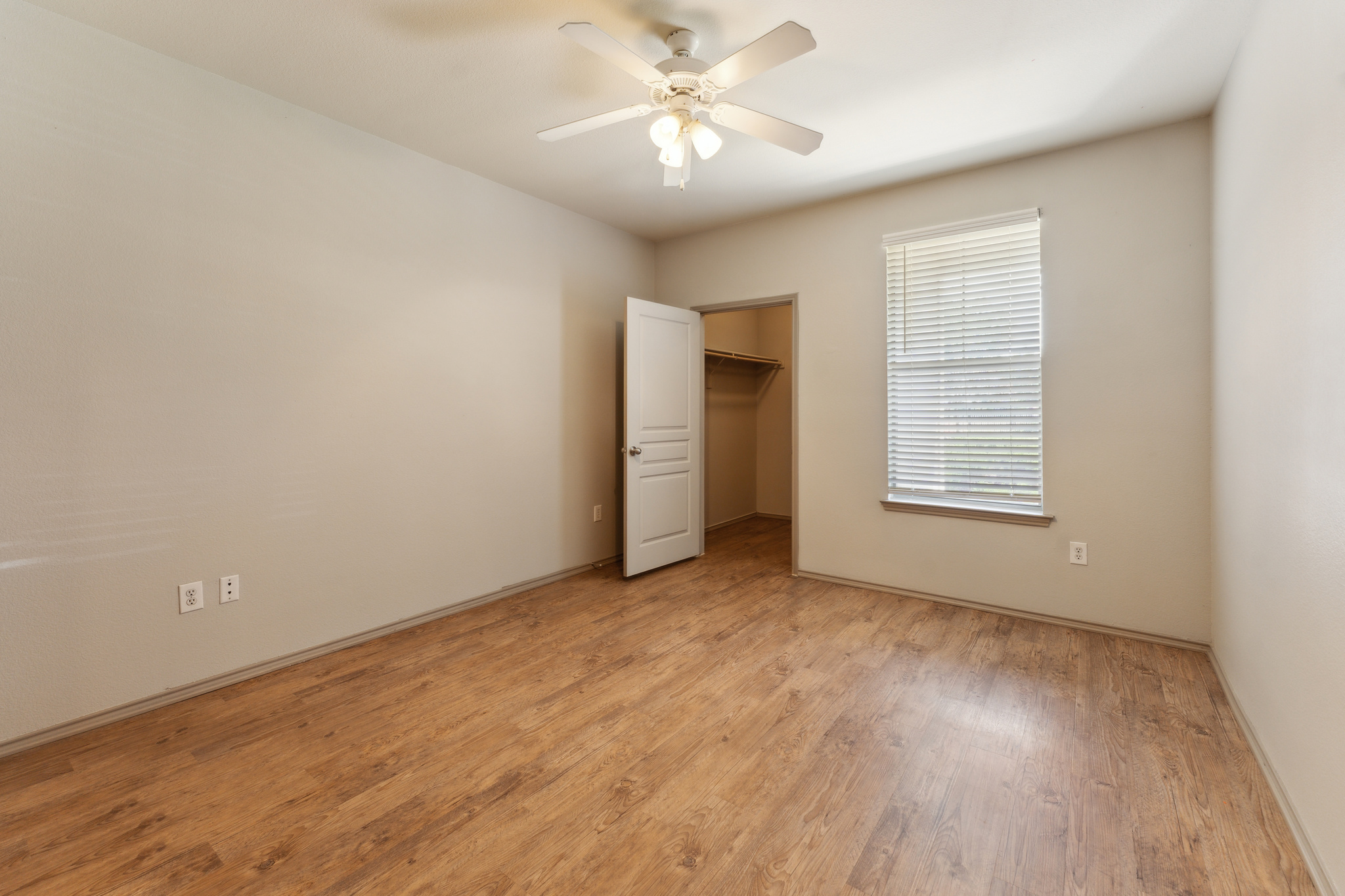 empty room with hardwood floors and ceiling fan at The  Wyatt at Presidio Junction