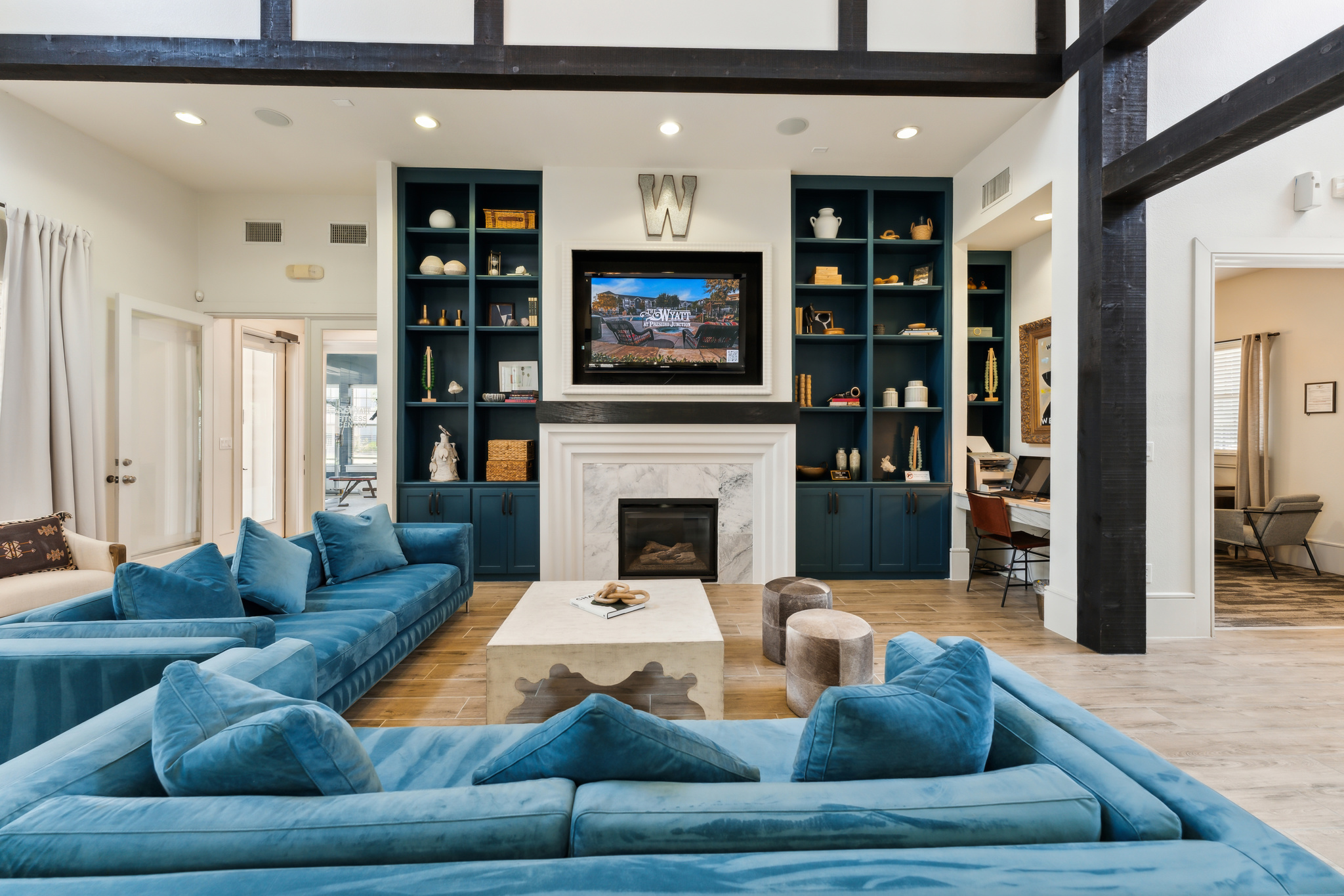 a living room with blue couches and a fireplace at The  Wyatt at Presidio Junction