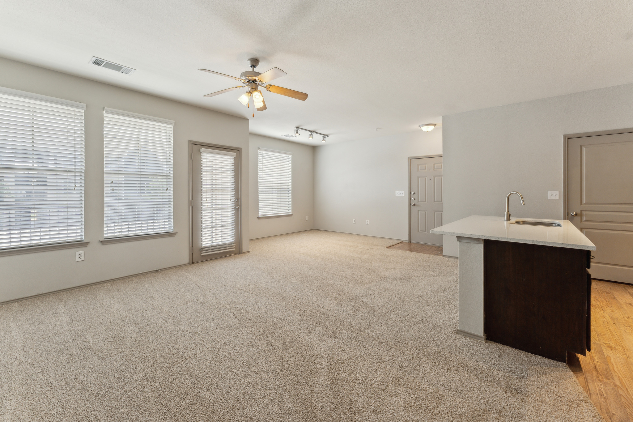empty living room with ceiling fan and carpet at The  Wyatt at Presidio Junction