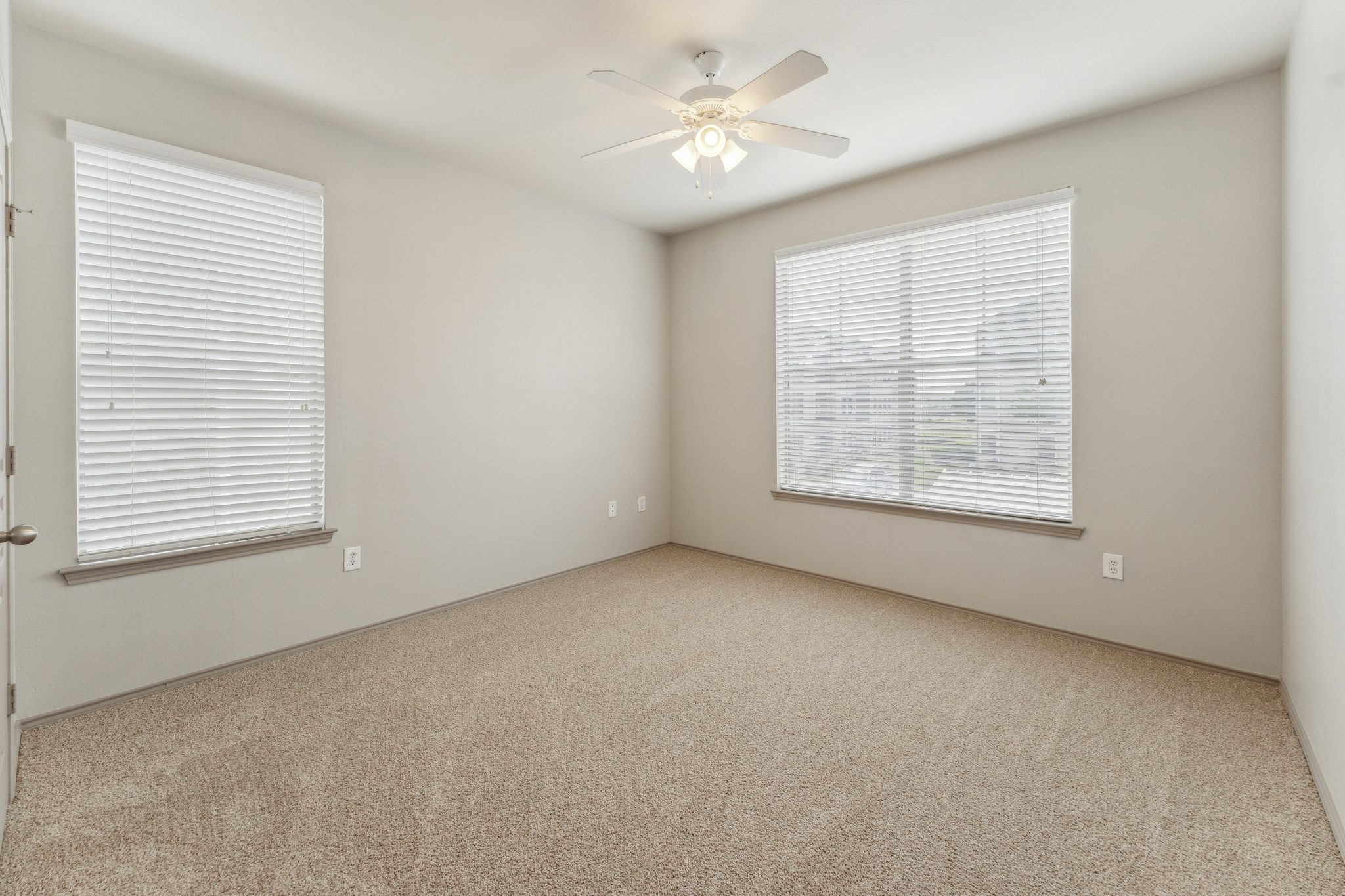 empty room with ceiling fan and carpet at The  Wyatt at Presidio Junction