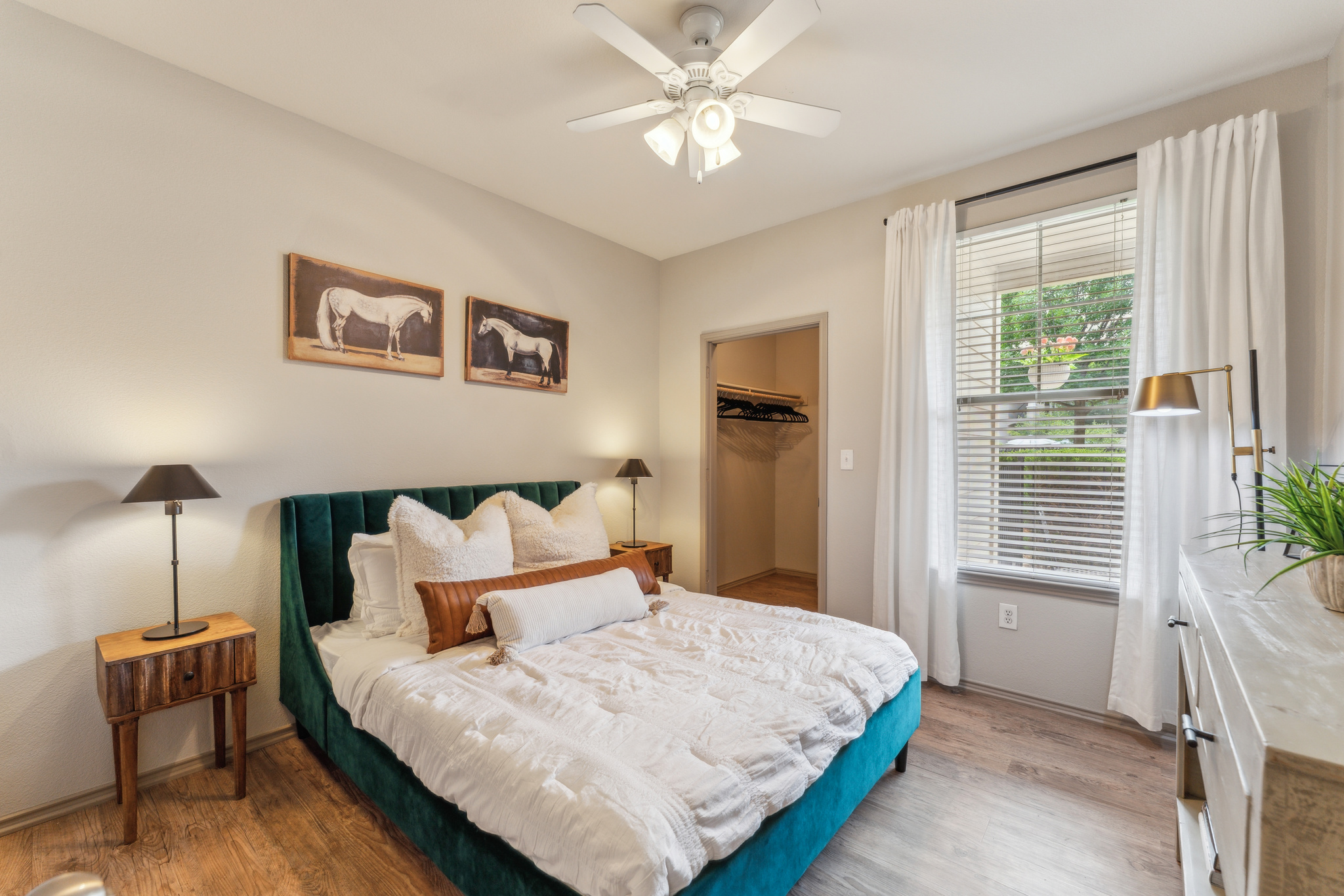 a bedroom with a bed, dresser and ceiling fan at The  Wyatt at Presidio Junction