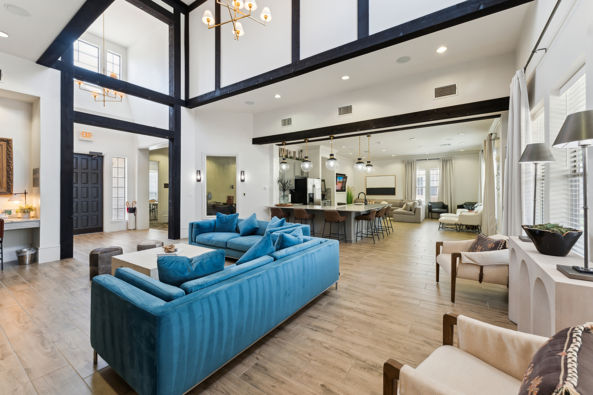 the living room has blue couches and a large window at The  Wyatt at Presidio Junction