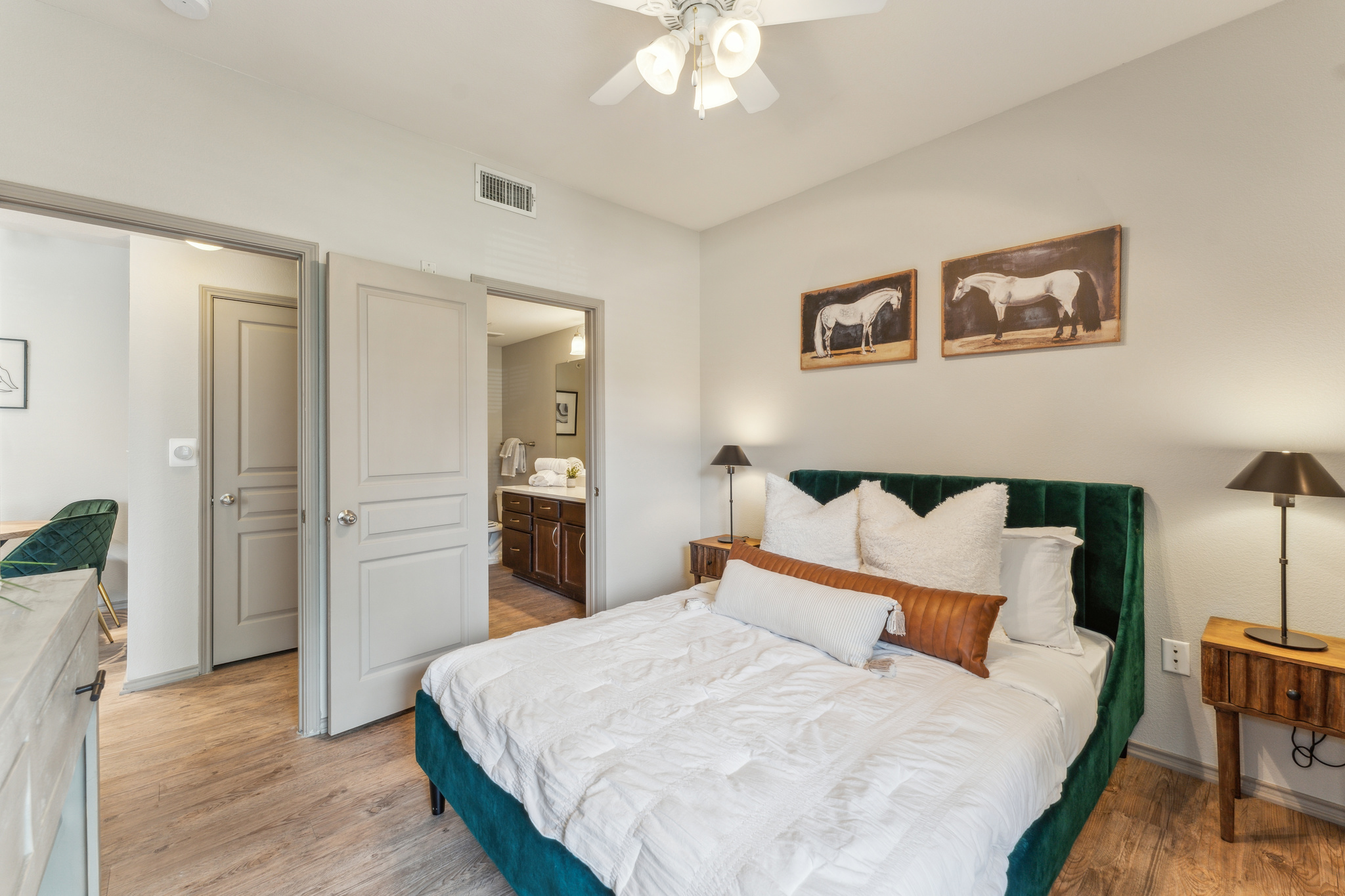a bedroom with a bed, a ceiling fan and a mirror at The  Wyatt at Presidio Junction